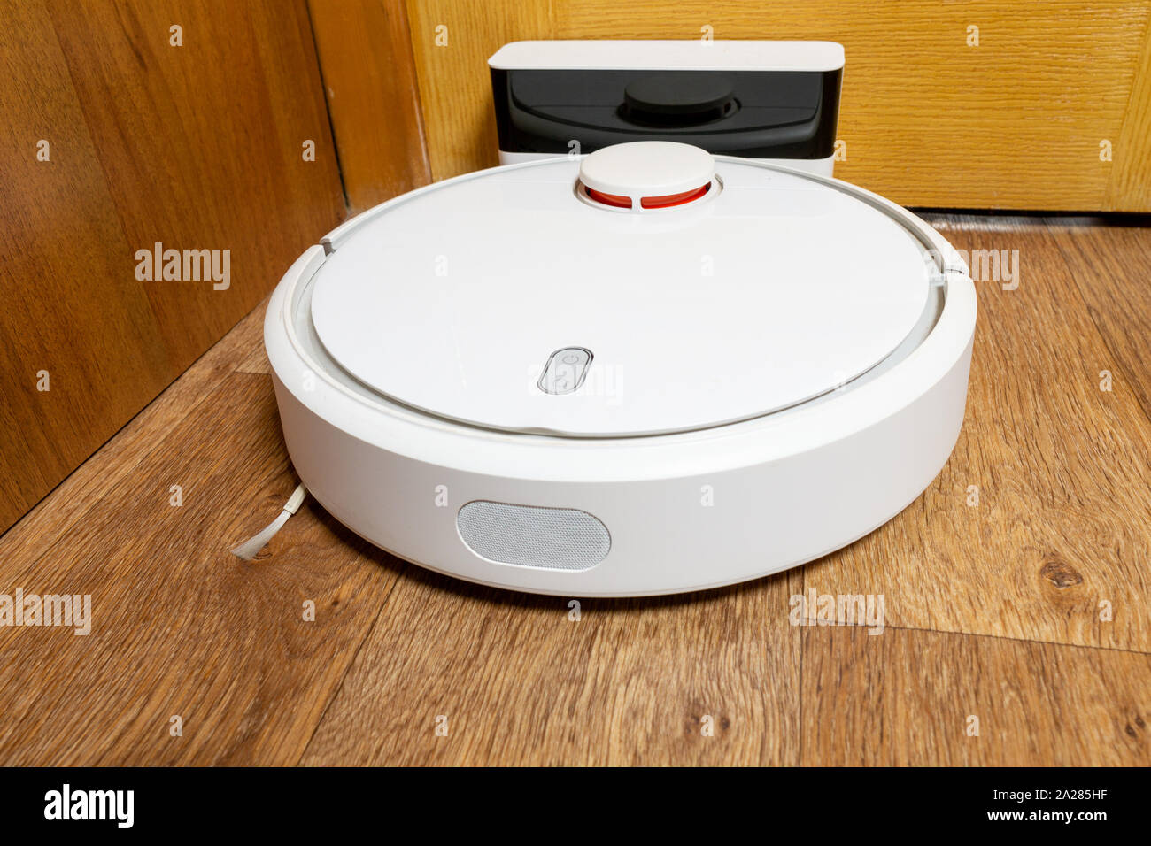 Robot vacuum cleaner is charging from the dockstation Stock Photo Alamy