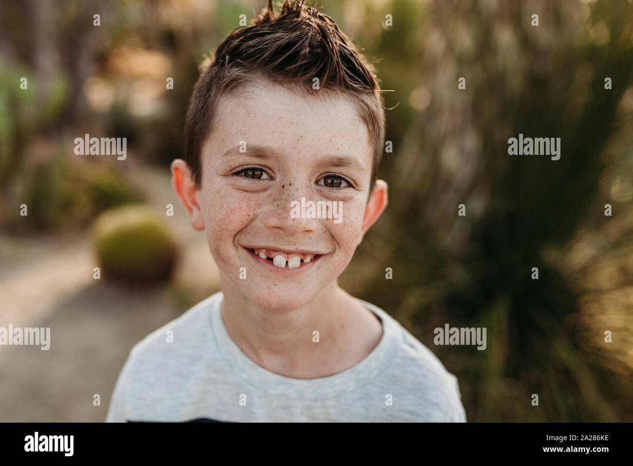 Close up portrait of cute young boy with freckles smiling Stock Photo