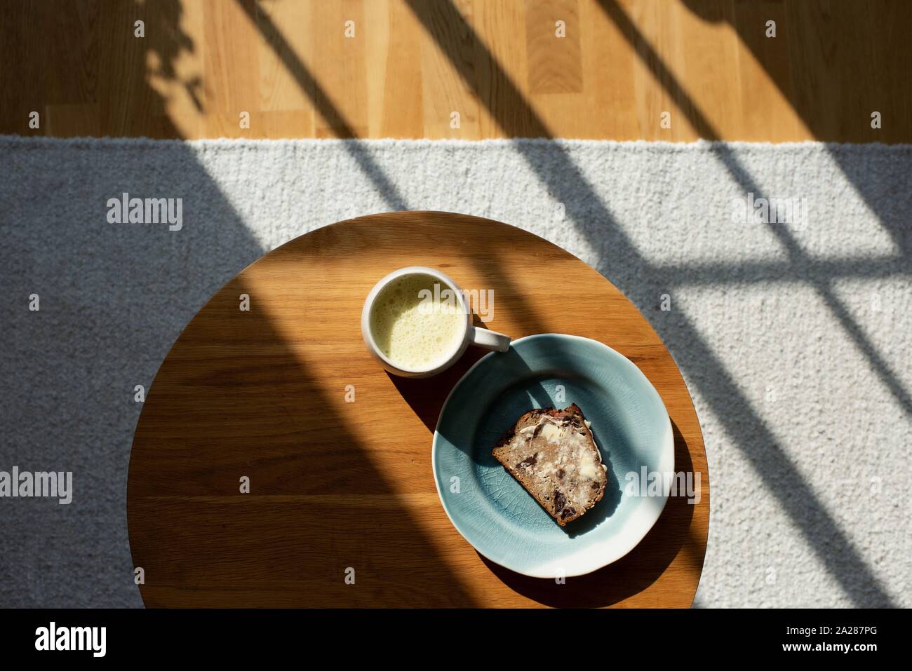 coffee and toast on a coffee table at home with beautiful window light Stock Photo