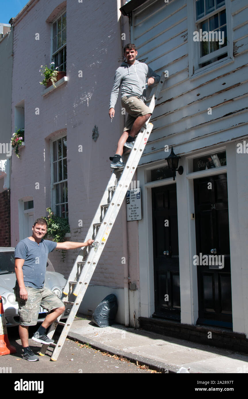 House painters with a ladder Stock Photo
