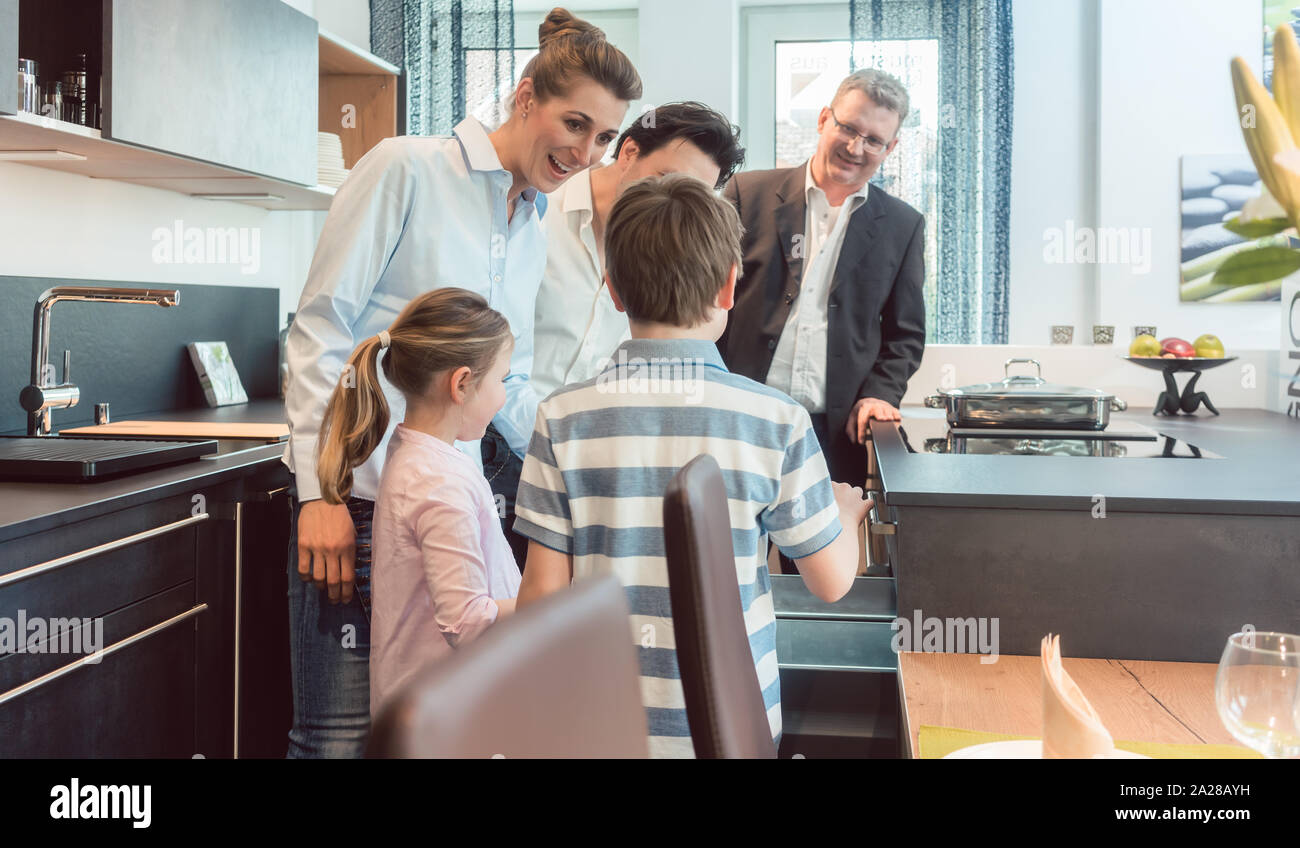 Kitchen sales with a family, kids, and a service expert Stock Photo