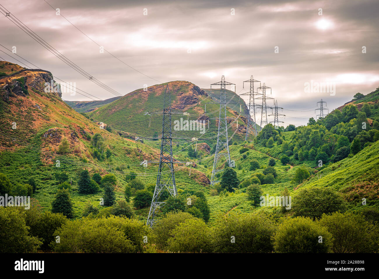 Pylons in Wales conducting electricity to the country with a stormy sky ...