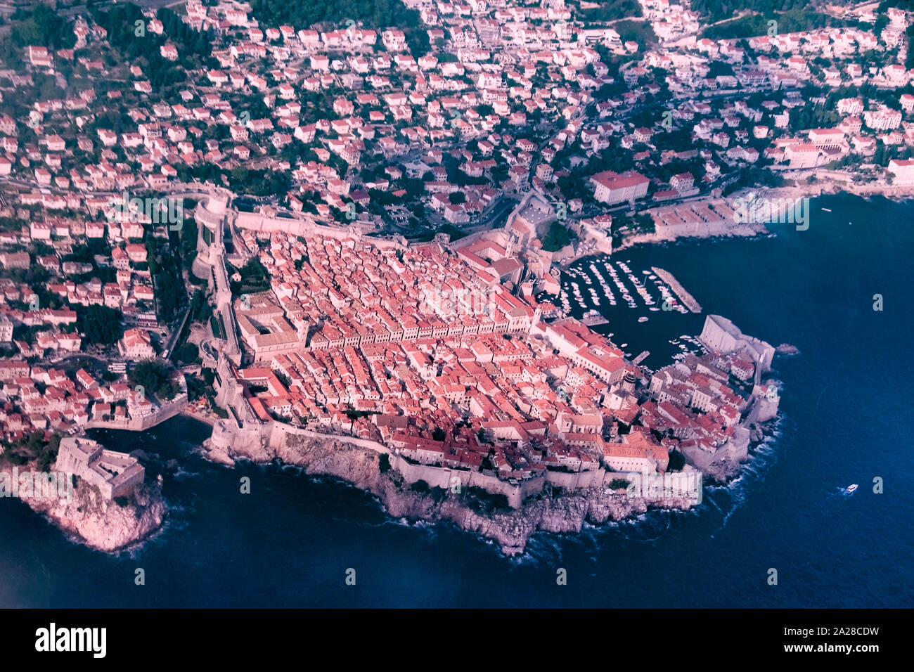 A view of Dubrovnik Old Town taken from the air. The image shows the entire Old city and port surrounded by the blue green clear Adriatic sea Stock Photo