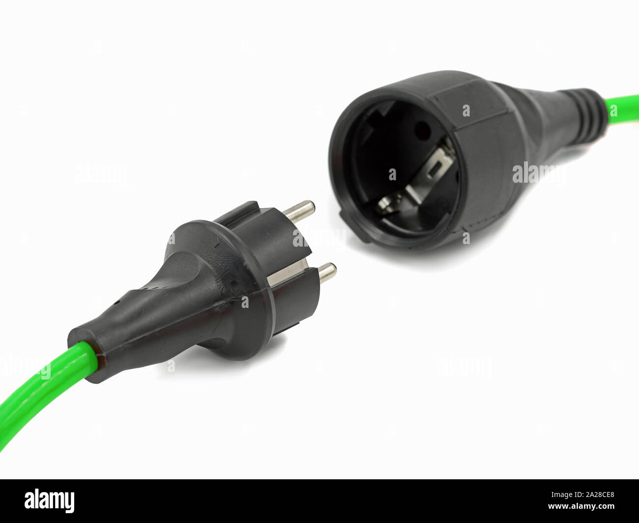 close up, disconnected green electrical power extension cable with EU plug, green energy Stock Photo