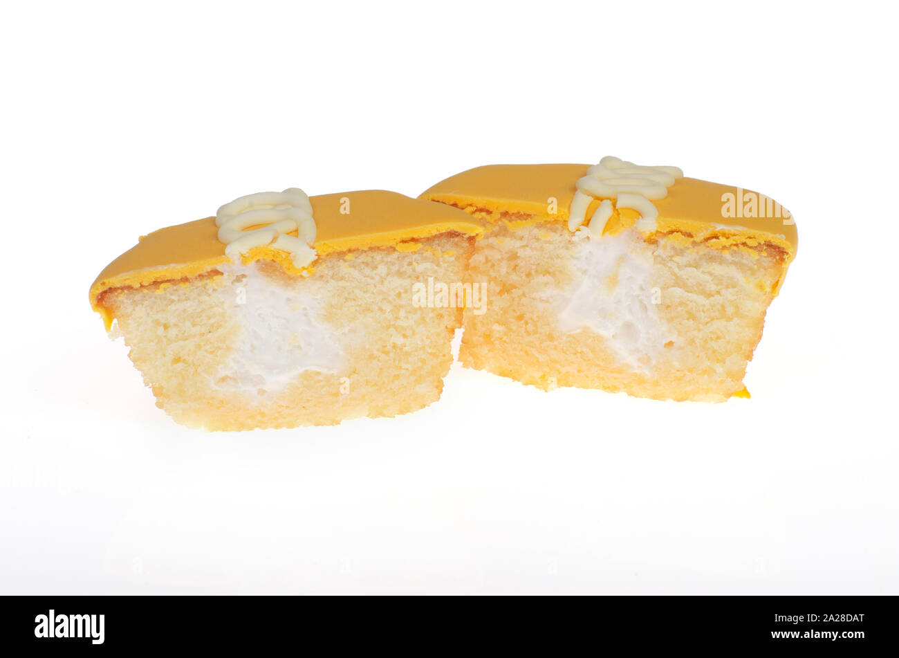 Hostess orange frosted cupcake cut in half showing creme filling Stock Photo