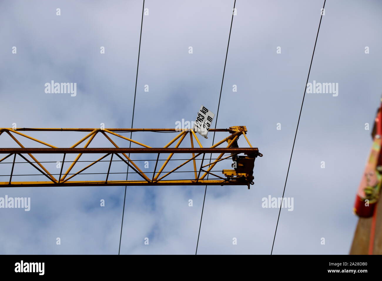 Crane moves at safety distance under a power line Stock Photo Alamy