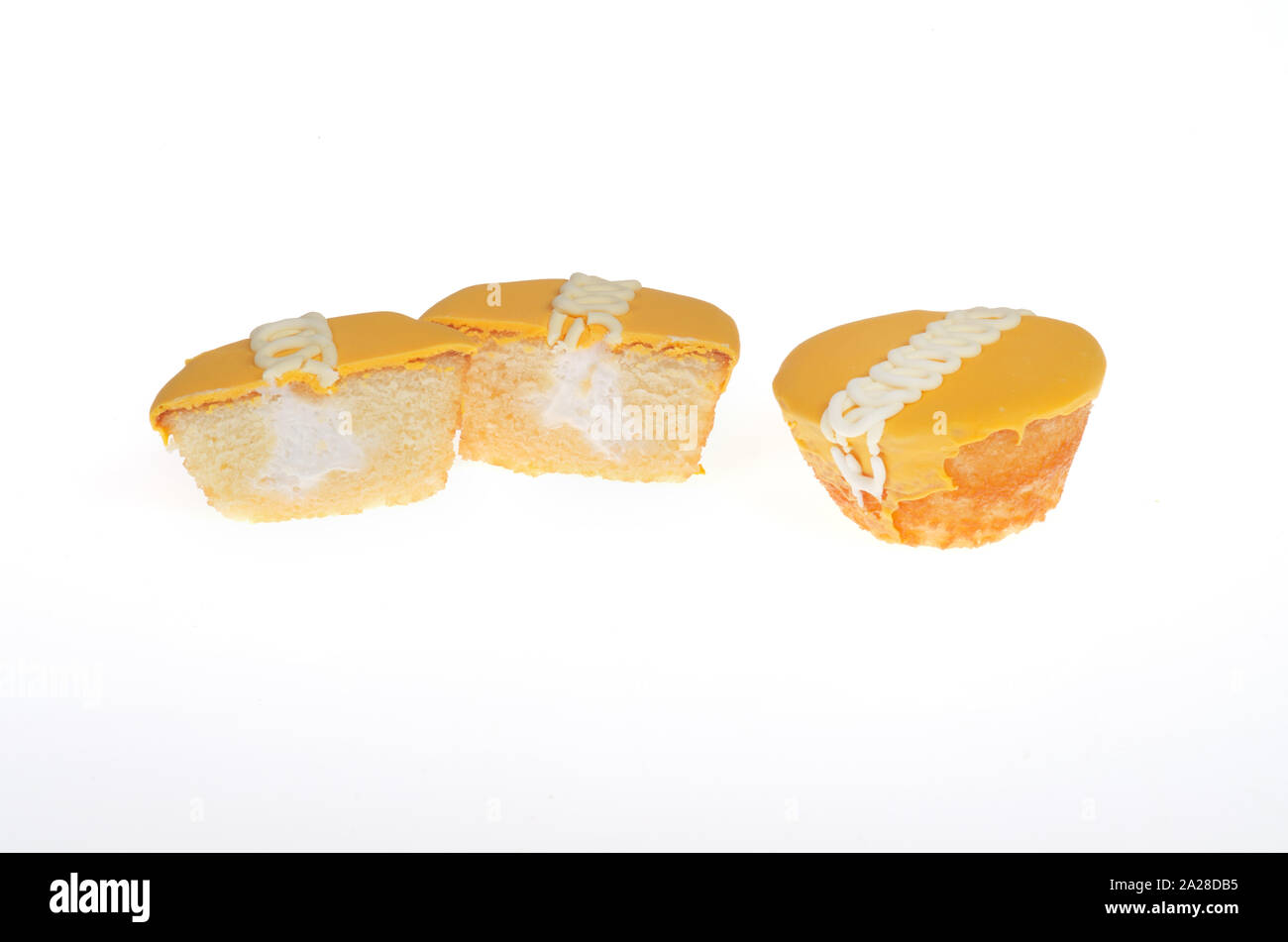Hostess Frosted Orange Flavor Creme Filled CupCakes, 1 whole and 1 cut in half Stock Photo