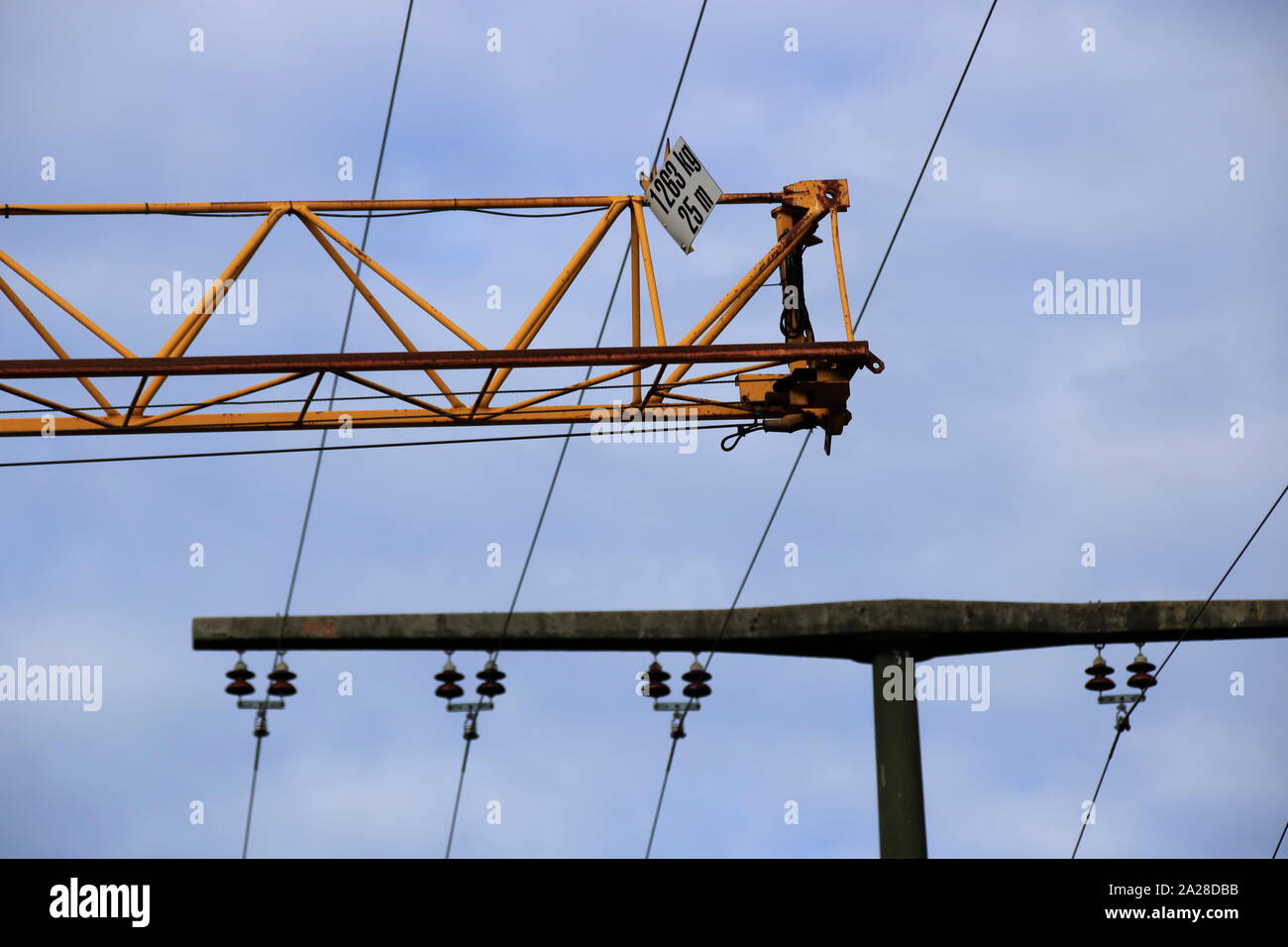 Crane moves at safety distance under a power line Stock Photo Alamy
