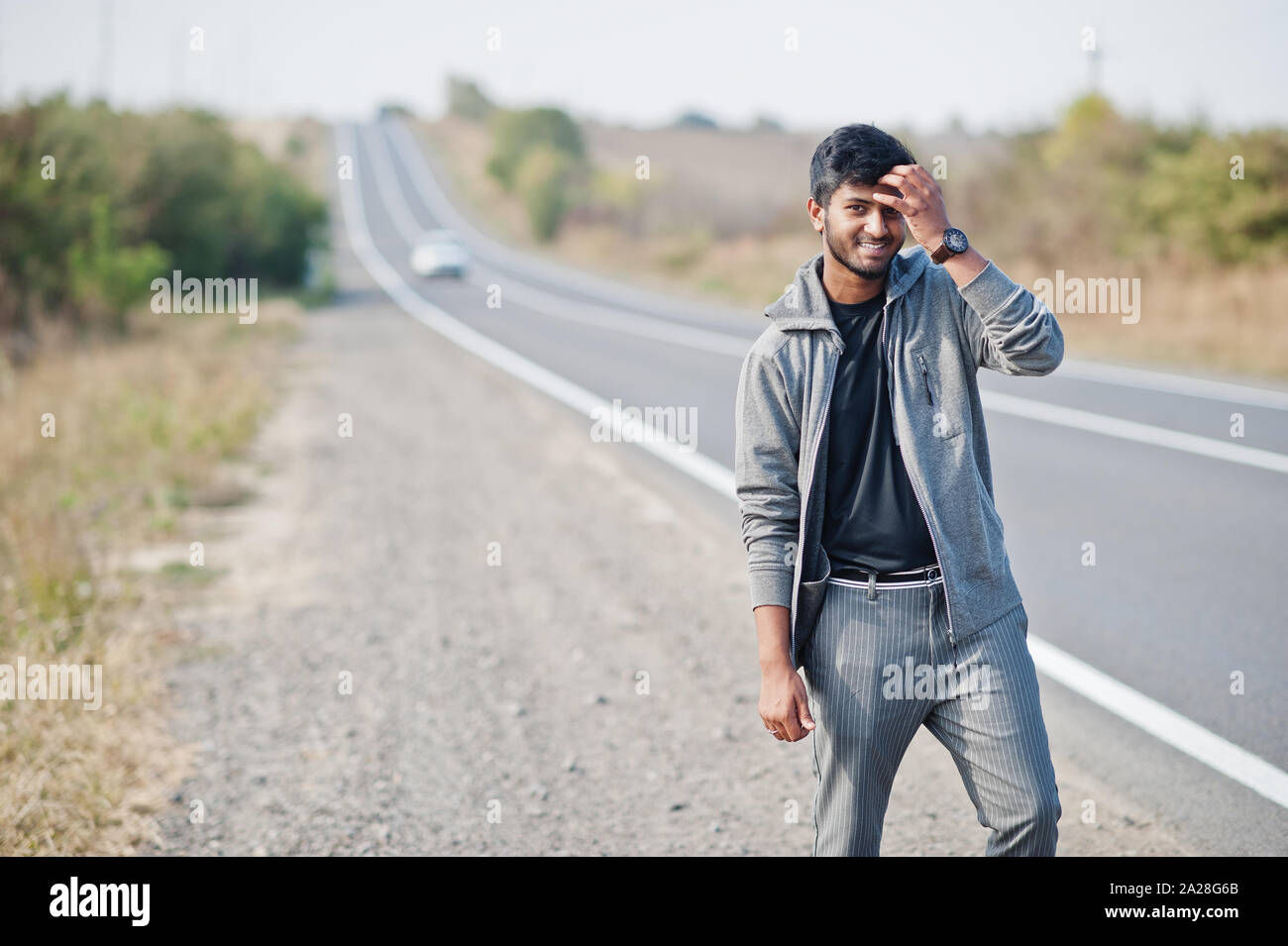 Hitchhiking indian man travelling by hitchhike on road side on highway  Stock Photo - Alamy