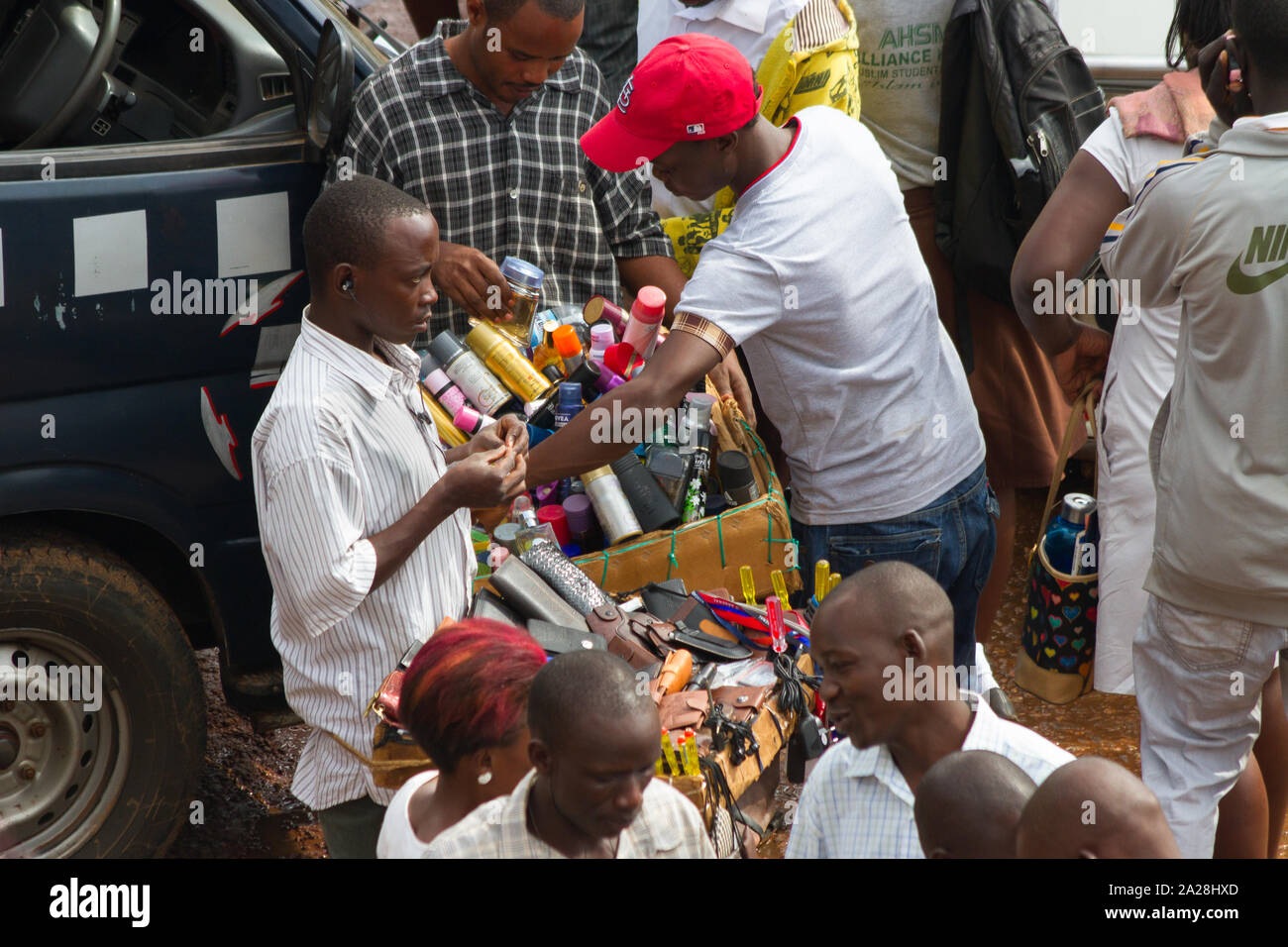 KAMPALA, UGANDA - OCTOBER 03, 2012.  A man sells wallets to passengers at the taxi park in Kampala, Uganda on October 03,2012. Stock Photo