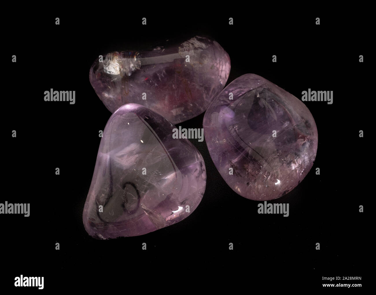 polished amethyst in front of black background Stock Photo - Alamy