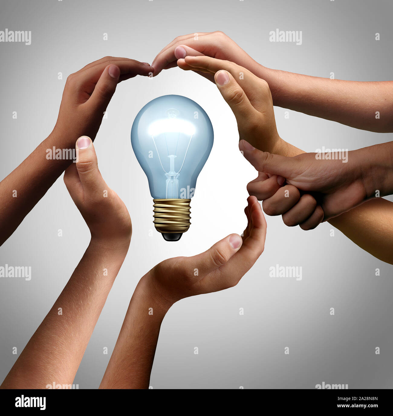 Inspire people thinking together as a diverse group coming together joining hands to collaborate into the shape of an inspirational light bulb. Stock Photo