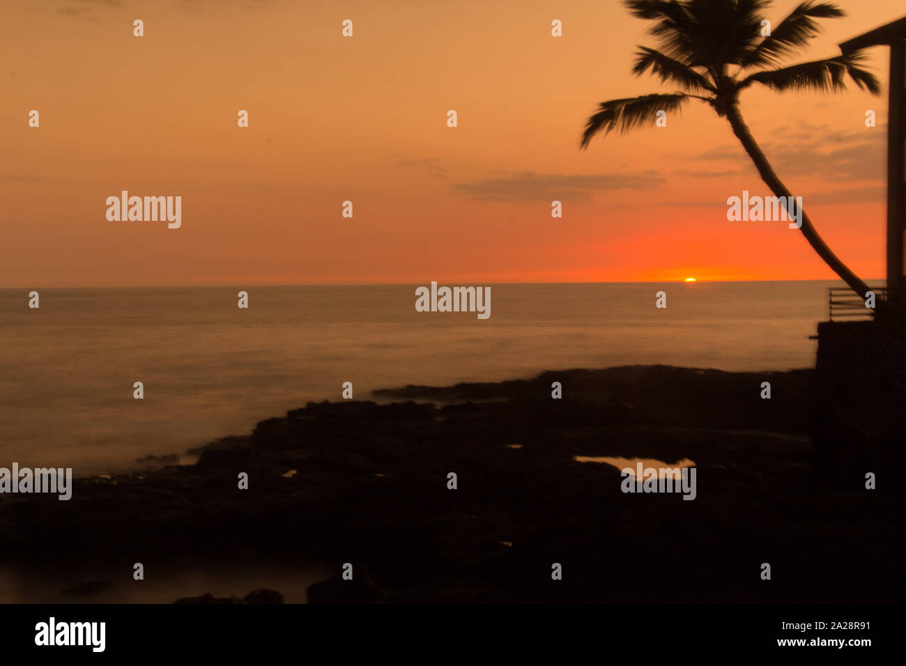 Colorful sunset over the sea in Heavenly Kona on Big Island Hawaii Stock Photo