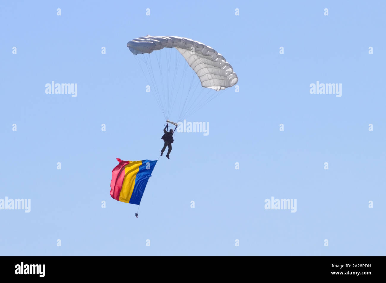 OSTRAVA, CZECH REPUBLIC - SEPTEMBER 22, 2019: NATO Days. Paratrooper descends after an airdrop over the airport, with Czech flag attached to him. Stock Photo