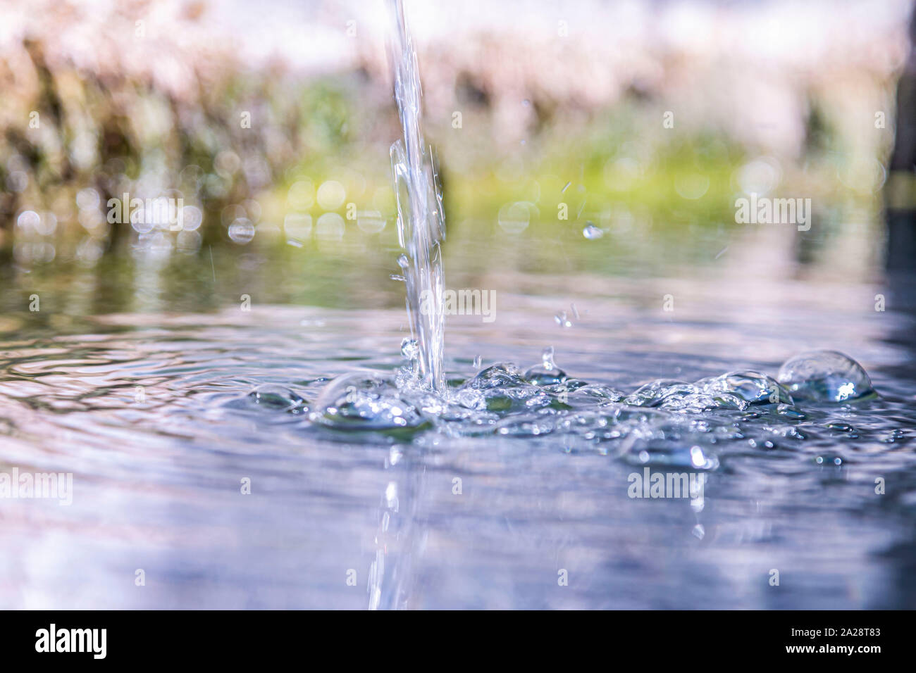 Natural spring water flows from the fountain Stock Photo Alamy