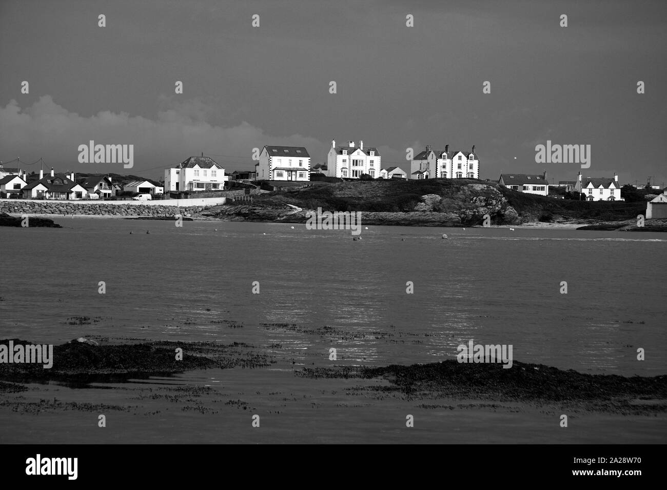 Houses across the water, Trearddur Bay, Anglesey, North Wales, UK Stock Photo