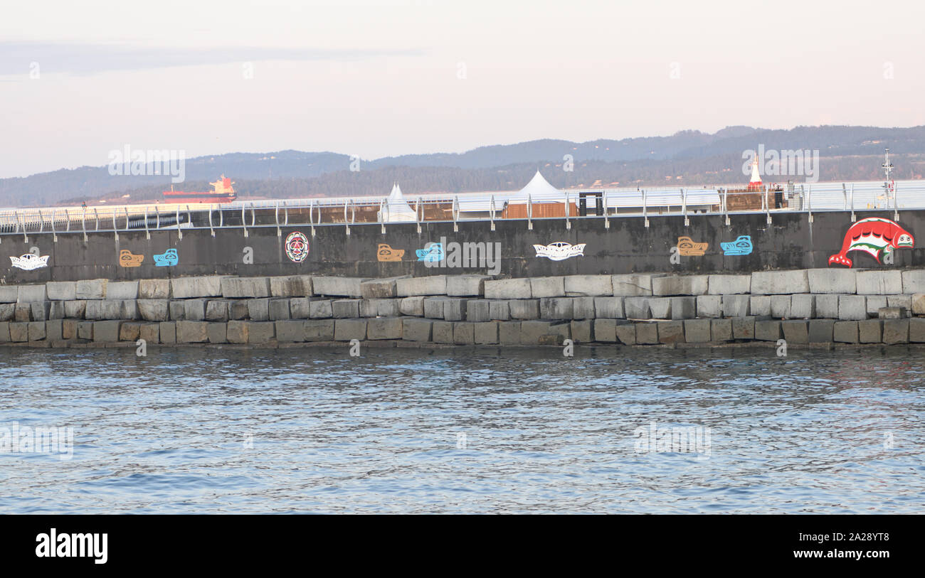 First Nations Breakwater Murals on the breakwater of James Bay. Victoria, British Columbia, Canada. Stock Photo