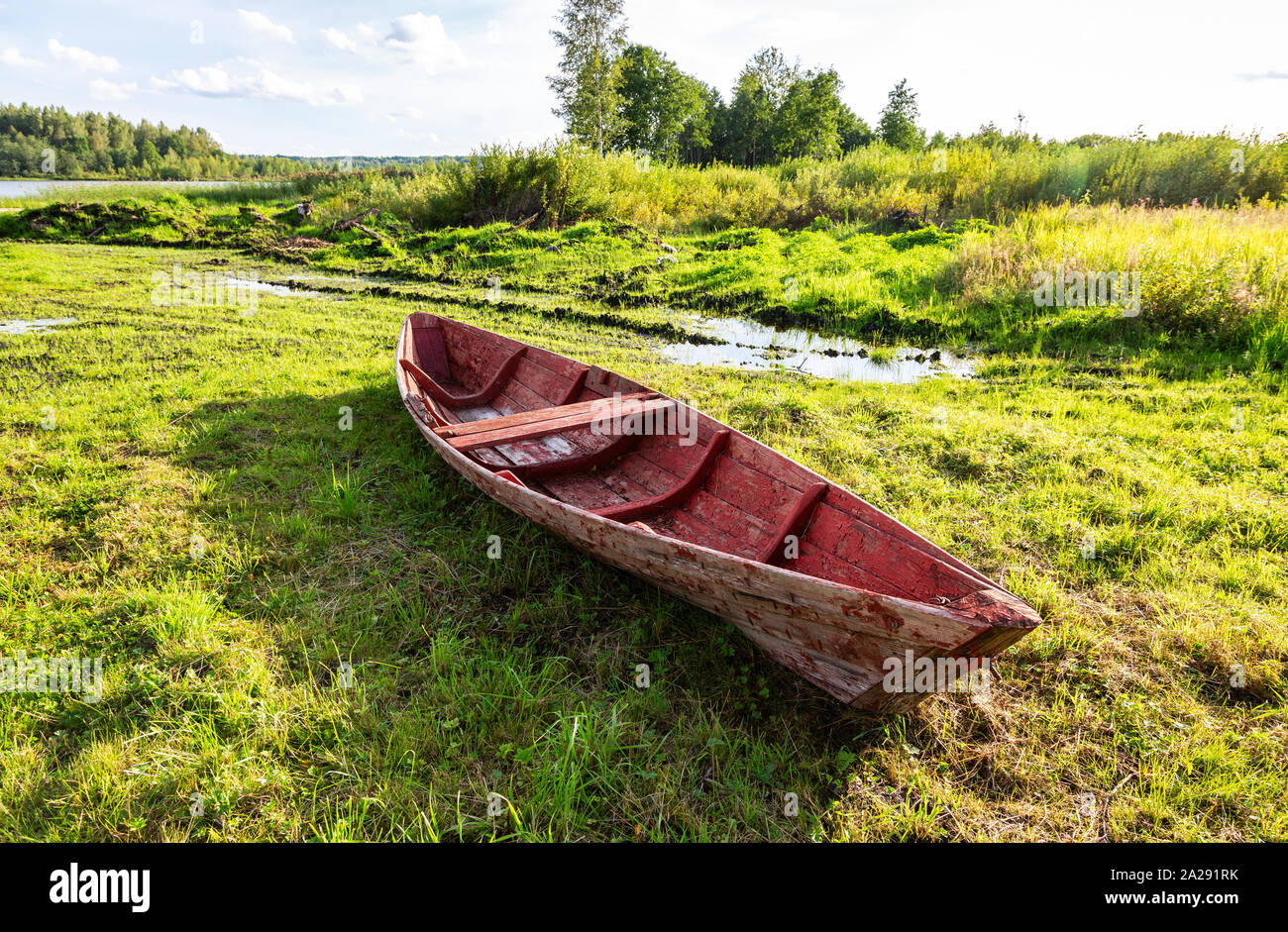 Old red wooden fishing boat at the lake in summer sunny day Stock Photo ...
