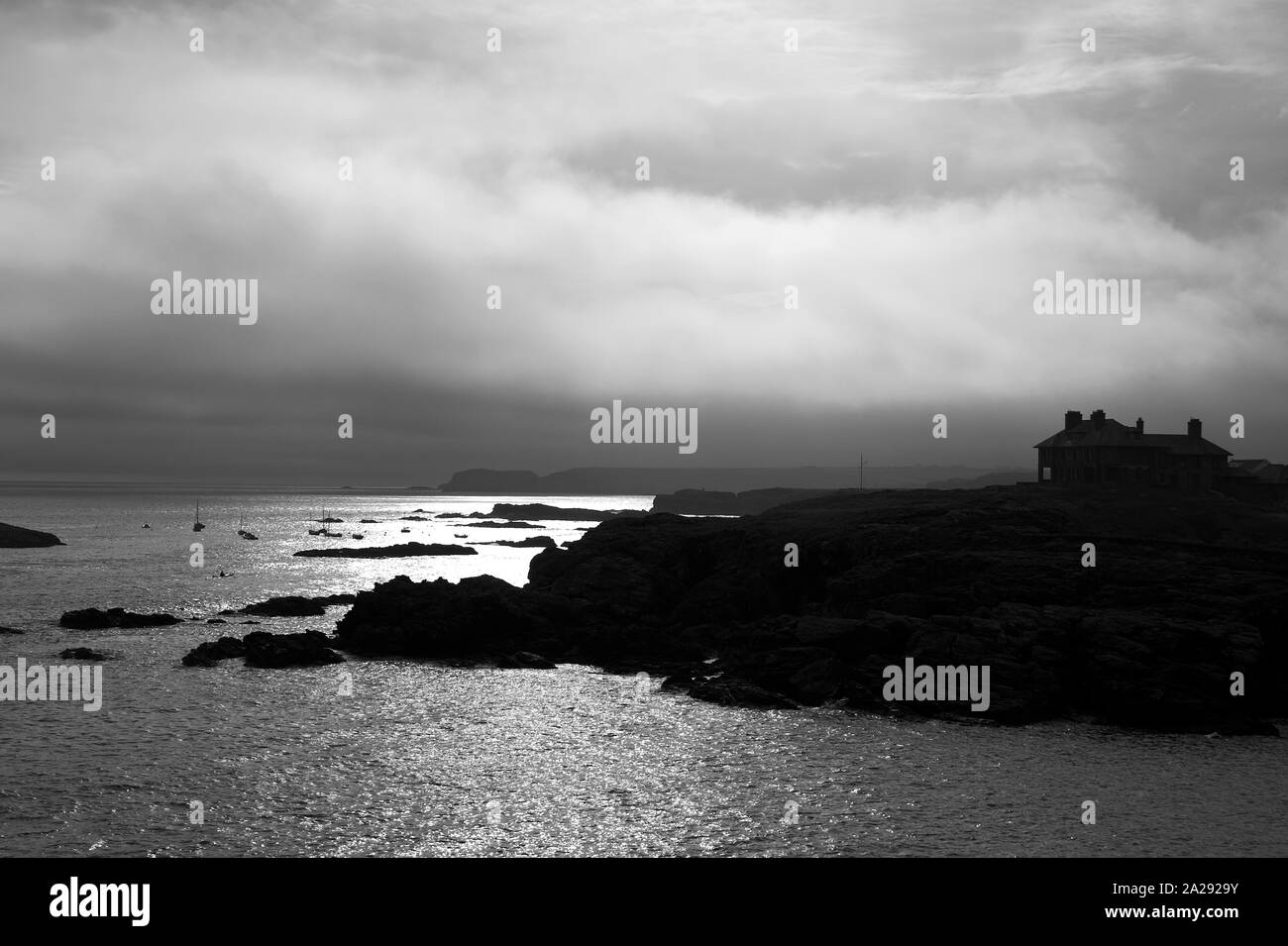 House silhouetted against the sky, overlooking the coast, Trearddur Bay, Anglesey, North Wales, UK Stock Photo