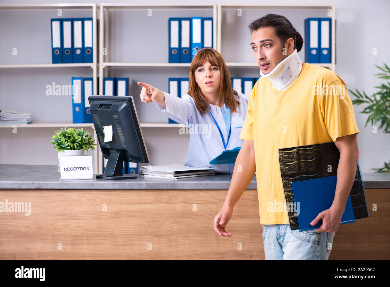 Random Hospital Reception The young patient at the reception in the hospital Stock Photo - Alamy