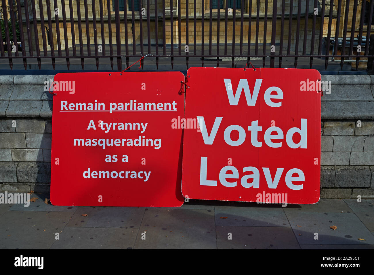 Placards in favour of leaving the European Union leaning against a wall outside the UK parliament building. Stock Photo