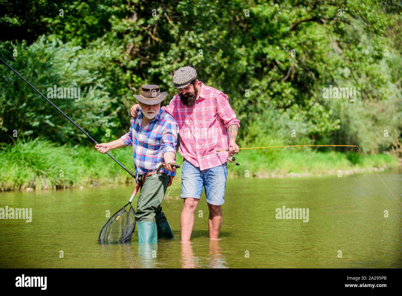 Fisherman family. Hobby sport activity. Summer weekend. Peaceful activity.  Father and son fishing. Nice catch. Rod and tackle. Fisherman fishing  equipment. Fisherman grandpa and mature man friends Stock Photo - Alamy