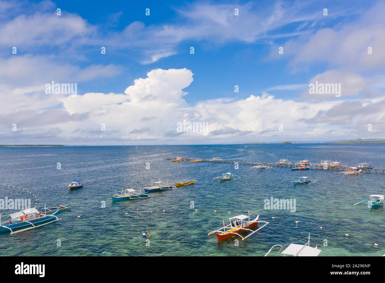 Seascape with boats and clouds. Many tourist boats in the bay during the day. Siargao, Philippines, view from above. Stock Photo