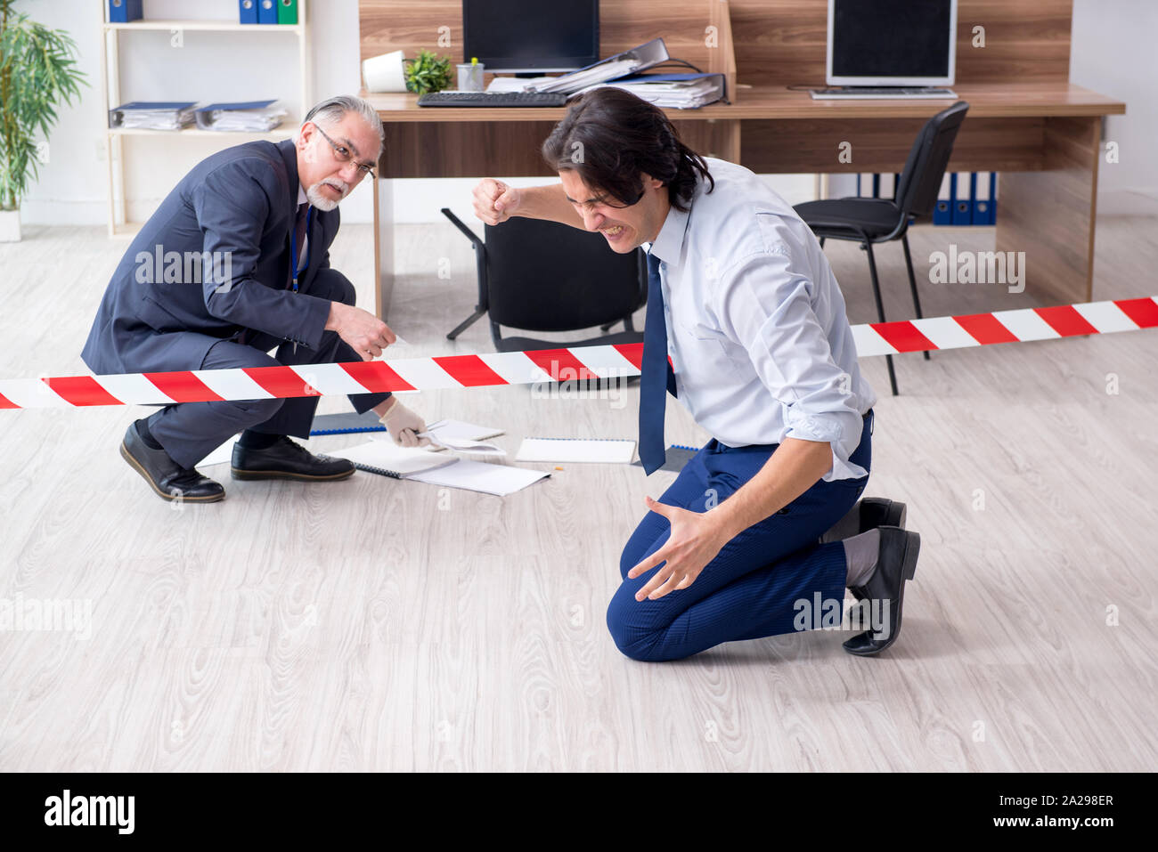 The forensic investigator investigating theft in the office Stock Photo