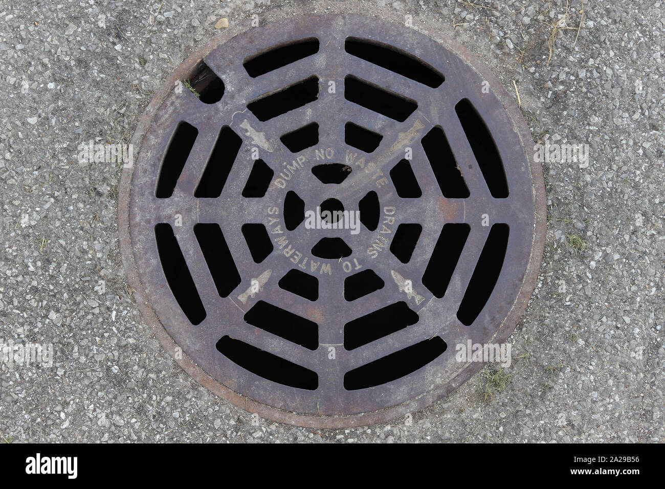 Man hole cover with fish on it. Stock Photo