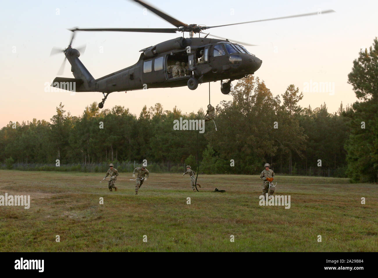 Paratroopers with 4th Infantry Brigade Combat Team (A), 25th Infantry Division, U.S. Army Alaska, fast-rope from a UH-60 Blackhawk during training at Camp Shelby, Mississippi, 29 Sept., 2019. The paratroopers conducted an Emergency Deployment Readiness Exercise, taking them from their home at Joint Base Elmendorf-Richardson, Alaska, and will continue training at Camp Shelby for more than 20 days. (U.S. Army photo by Sgt. Alex Skripnichuk) Stock Photo