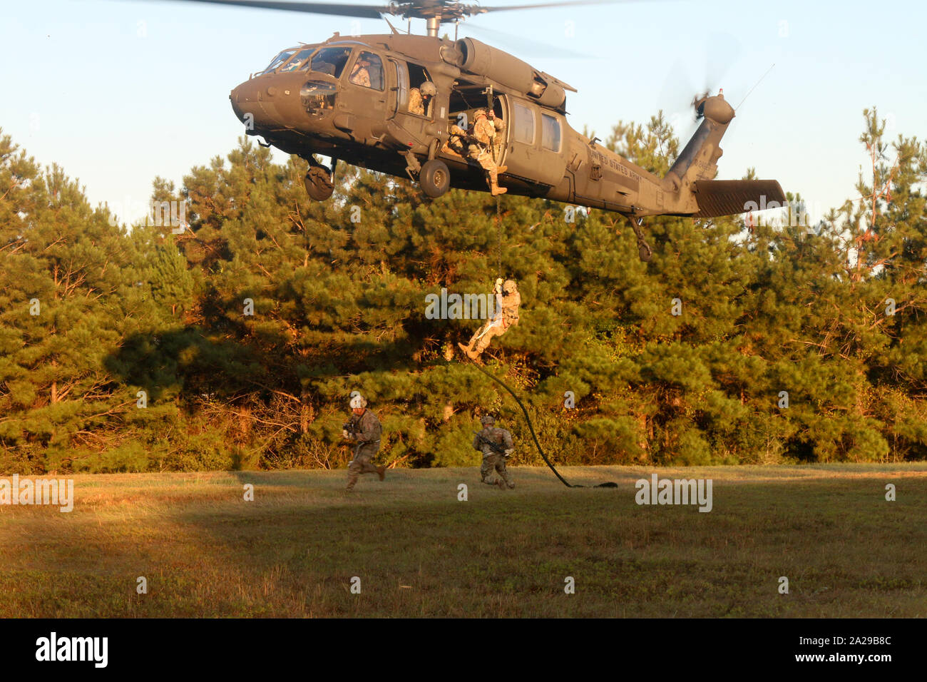 Paratroopers with 4th Infantry Brigade Combat Team (A), 25th Infantry Division, U.S. Army Alaska, fast-rope from a UH-60 Blackhawk during training at Camp Shelby, Mississippi, 29 Sept., 2019. The paratroopers conducted an Emergency Deployment Readiness Exercise, taking them from their home at Joint Base Elmendorf-Richardson, Alaska, and will continue training at Camp Shelby for more than 20 days. (U.S. Army photo by Cpt. Ashley Bainsangster) Stock Photo