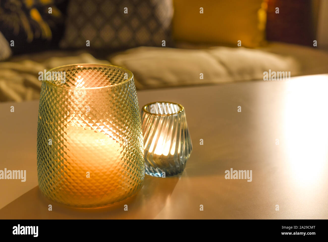 Cosy room interior inside a family home living room with candle light Stock Photo