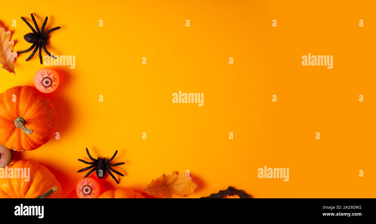 Halloween scene on orange background Stock Photo - Alamy