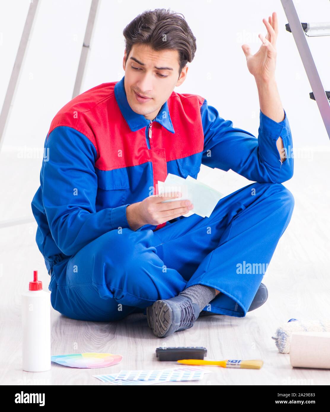 The young painter trying to match colours for painting job Stock Photo