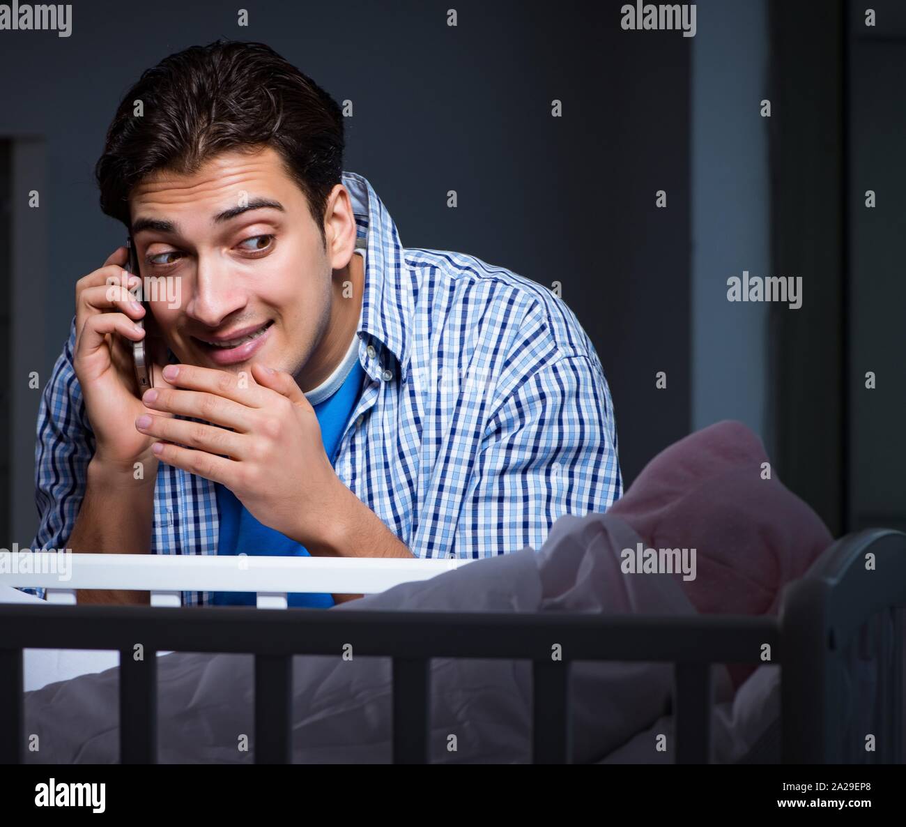 Happy dad looking after newborn baby at night Stock Photo