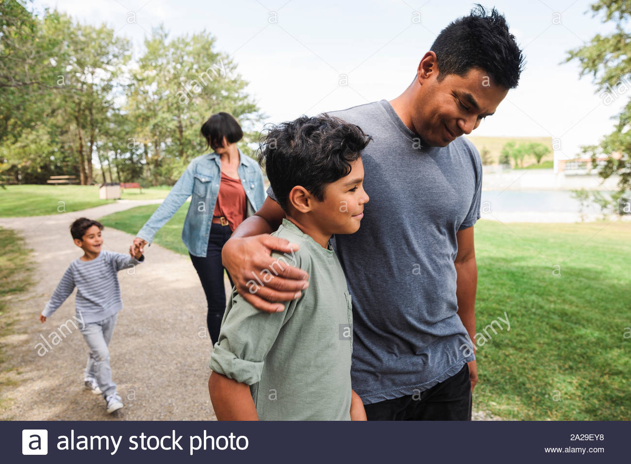 Family walking in urban park Stock Photo