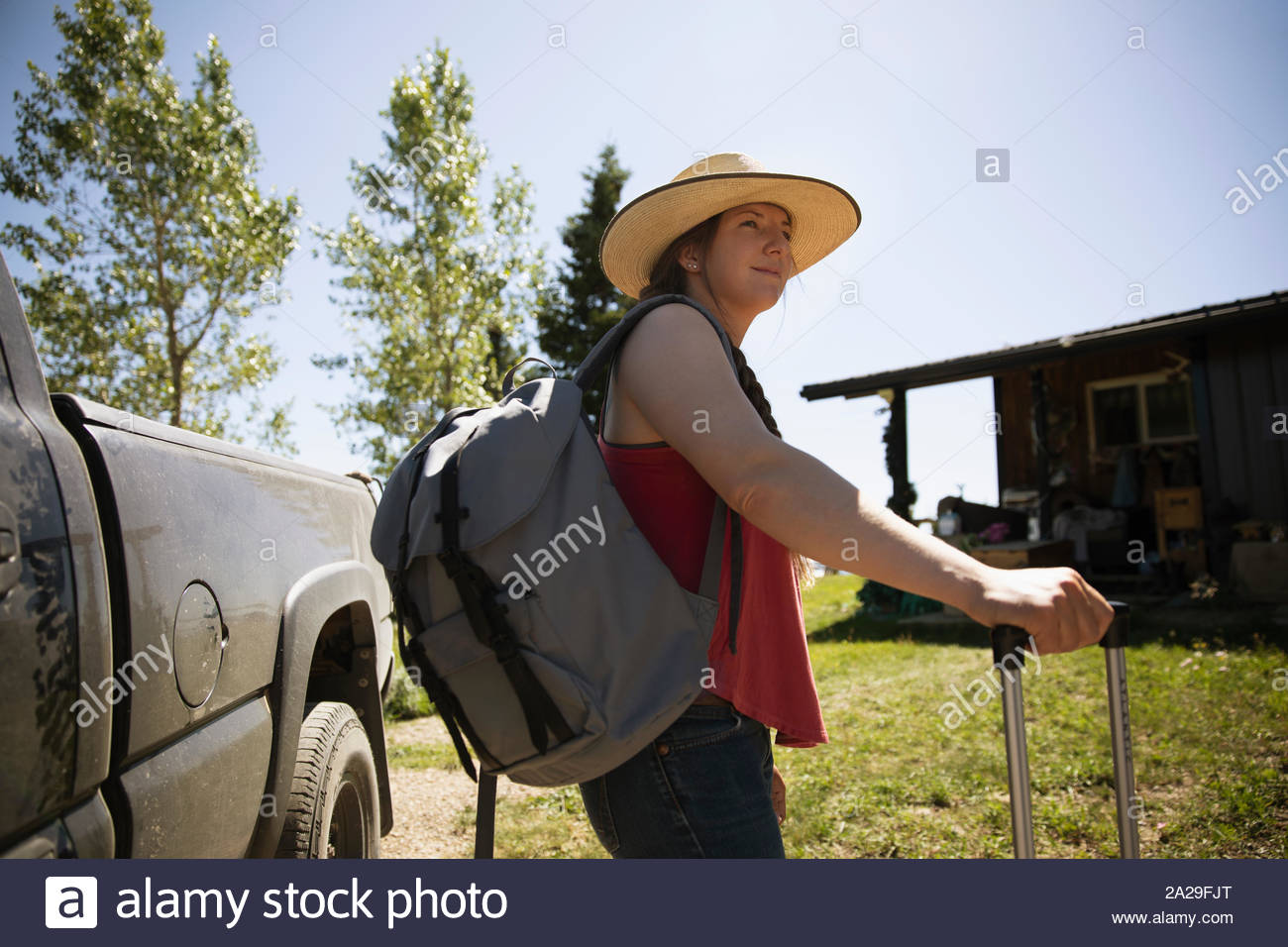Woman with backpack by truck Stock Photo