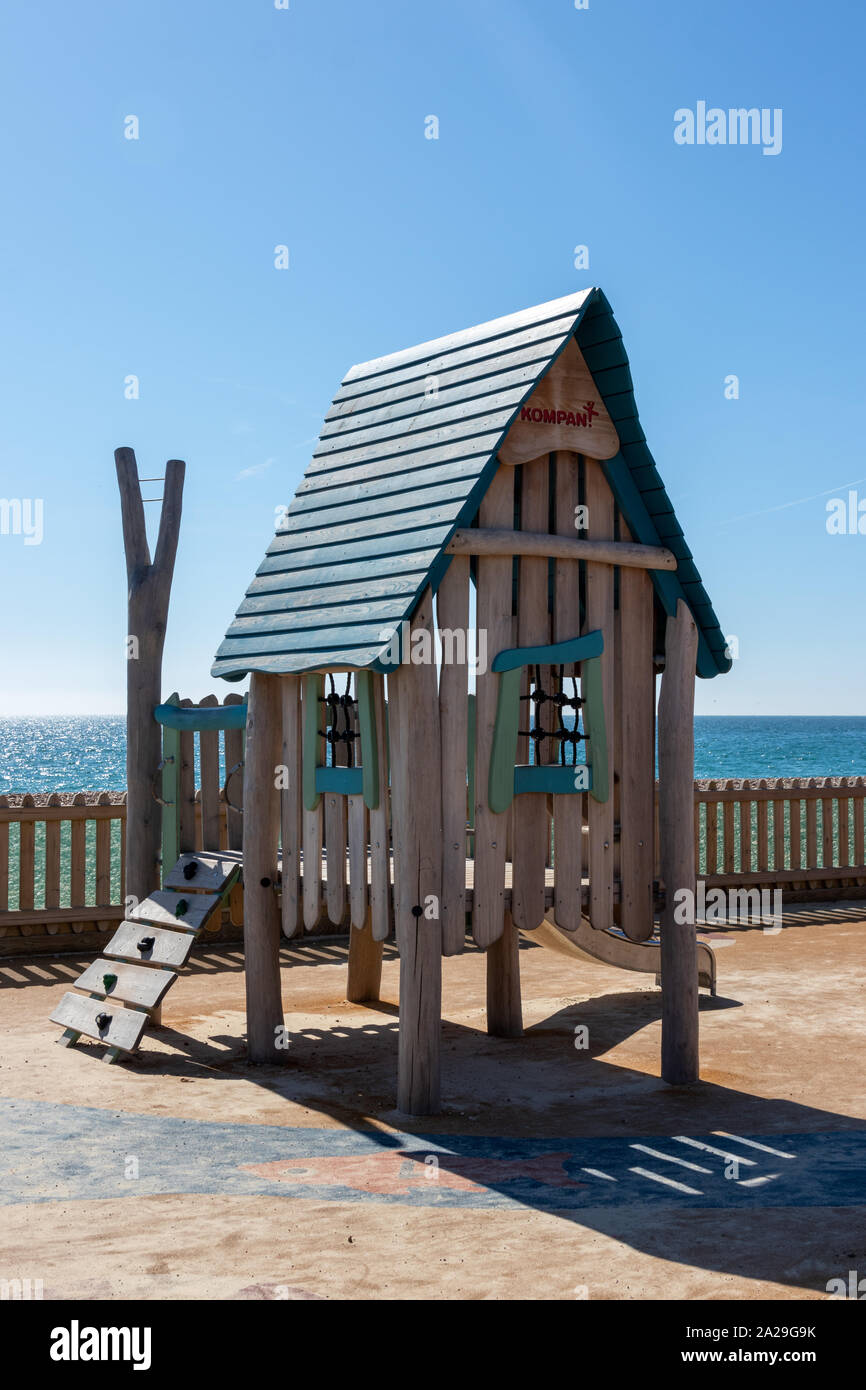 A child's climbing frame and tree house in a playground Stock Photo