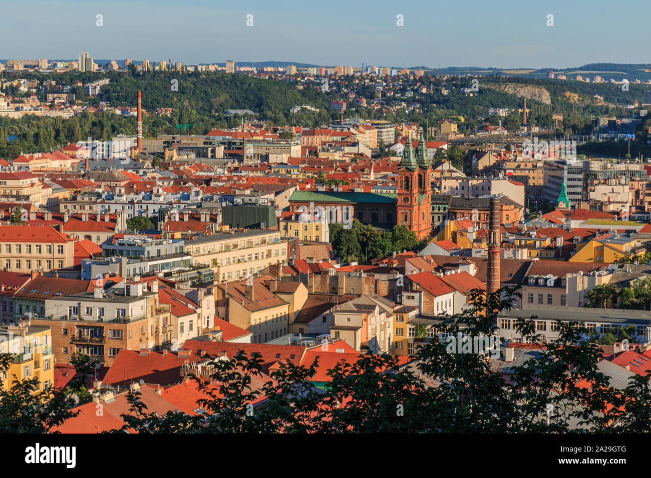 Panoramic view over the rooftops and historical buildings of Prague the capital of Czechia with St. Wenceslas on Zderaz in a sunny day with blue sky Stock Photo