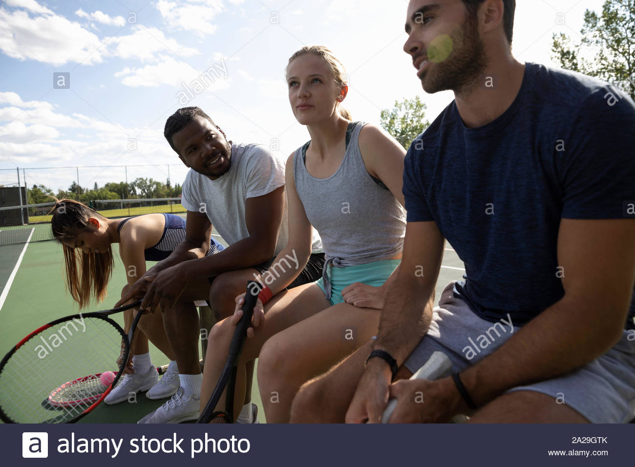 Young couples preparing to play tennis Stock Photo