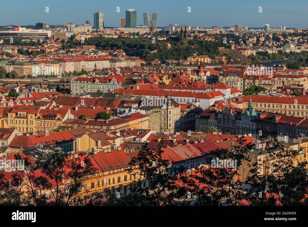 Panoramic view over the rooftops and historic buildings of the Prague Mala Strana district and the river Vltava on a sunny day with blue sky Stock Photo