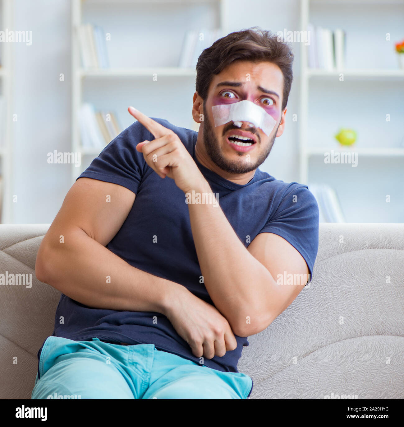 Young man recovering healing at home after plastic surgery nose job