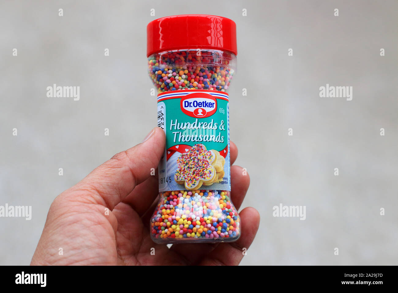 Hand holding Dr. Oetker Hundreds and Thousands edible colourful sprinkles Stock Photo