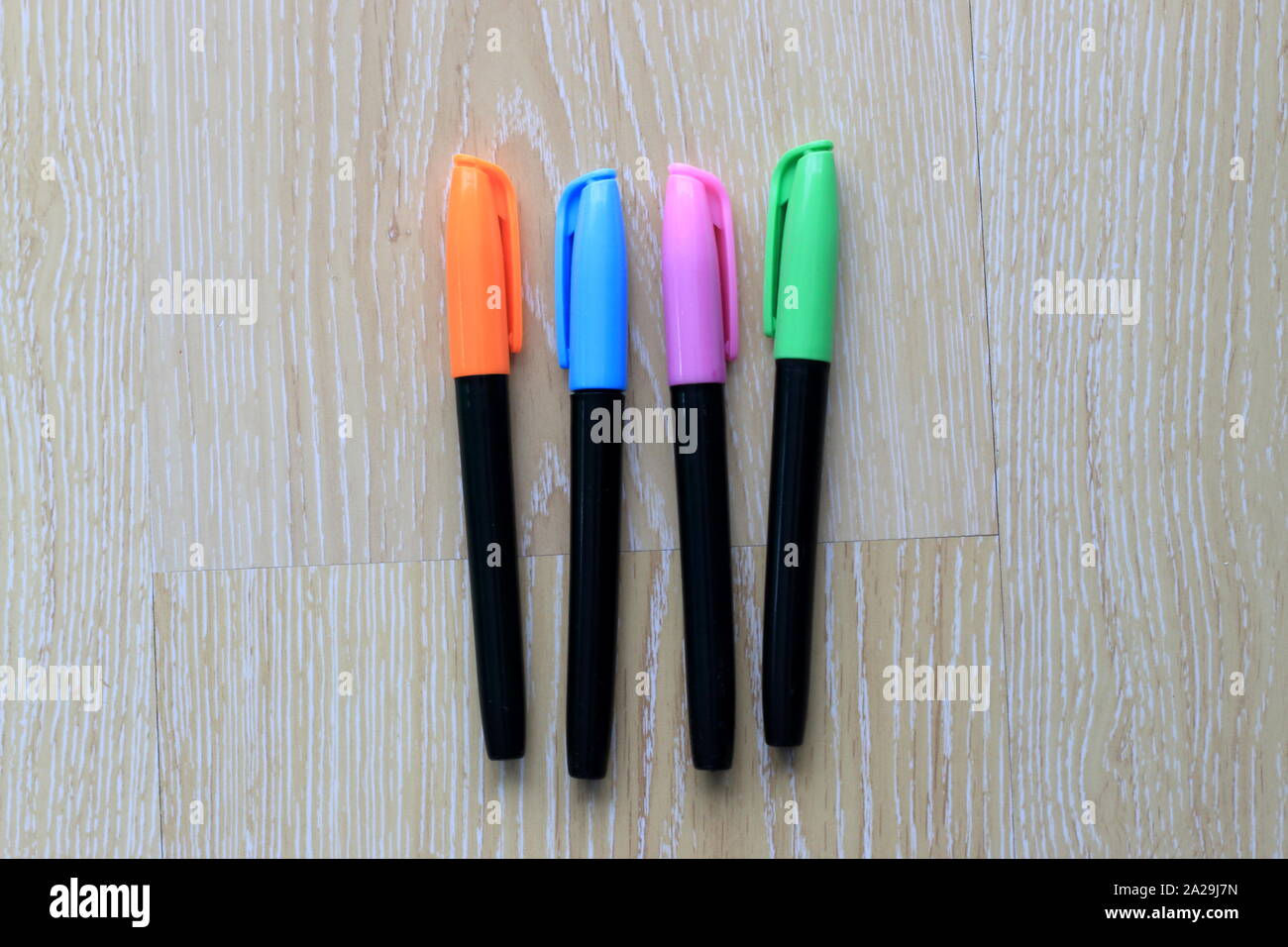 Set of coloured marker pens on wooden background Stock Photo