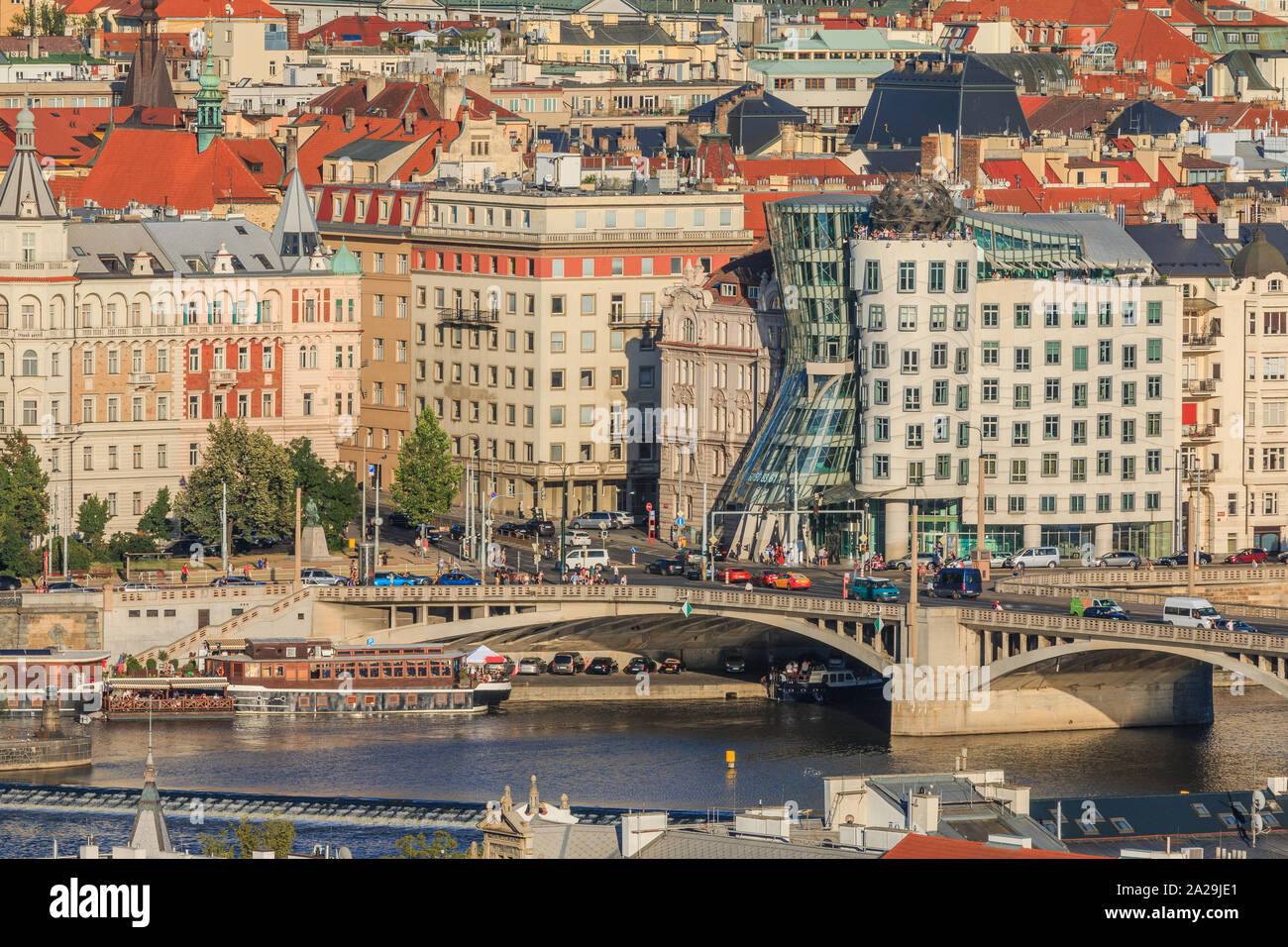 Outlook on city center of Prague. Historic buildings from the district Mala Strana with the river Vltava and the streets, the bridge, ships at the sho Stock Photo