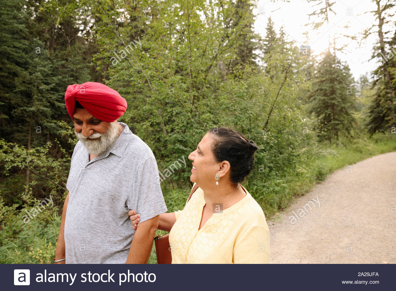 Senior couple walking on path in park Stock Photo