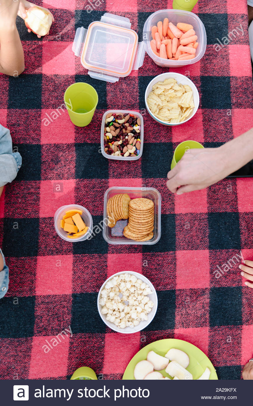 Picnic blanket with healthy food and snack, overhead view Stock Photo