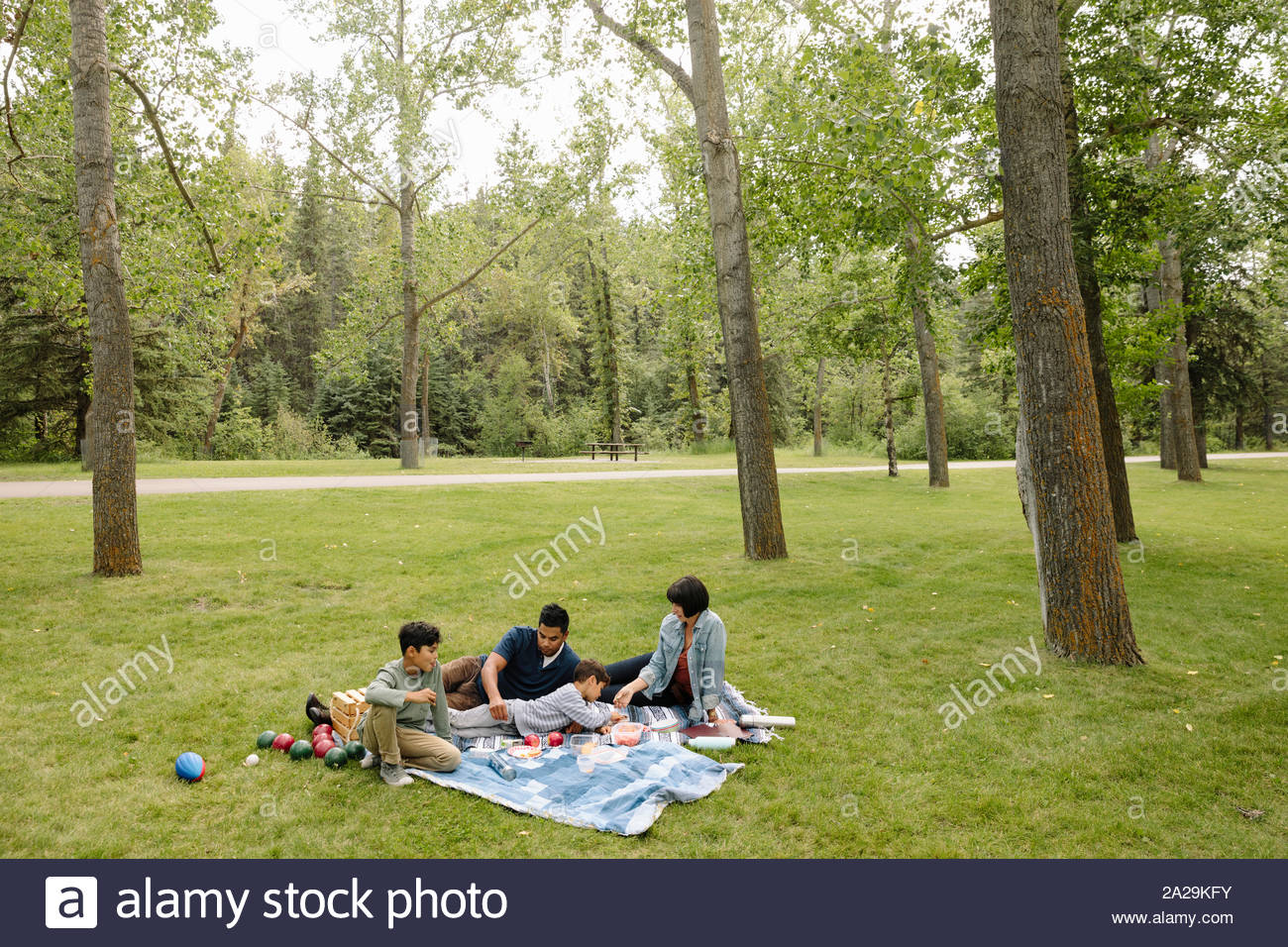 Family having picnic in urban park Stock Photo - Alamy