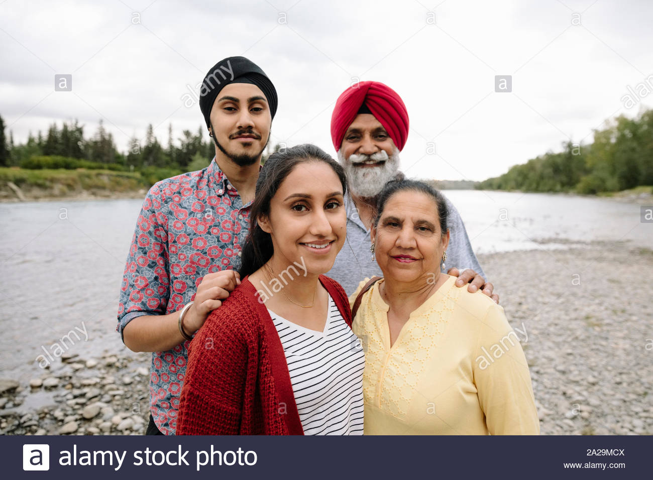Portrait of Indian family on lakeshore Stock Photo