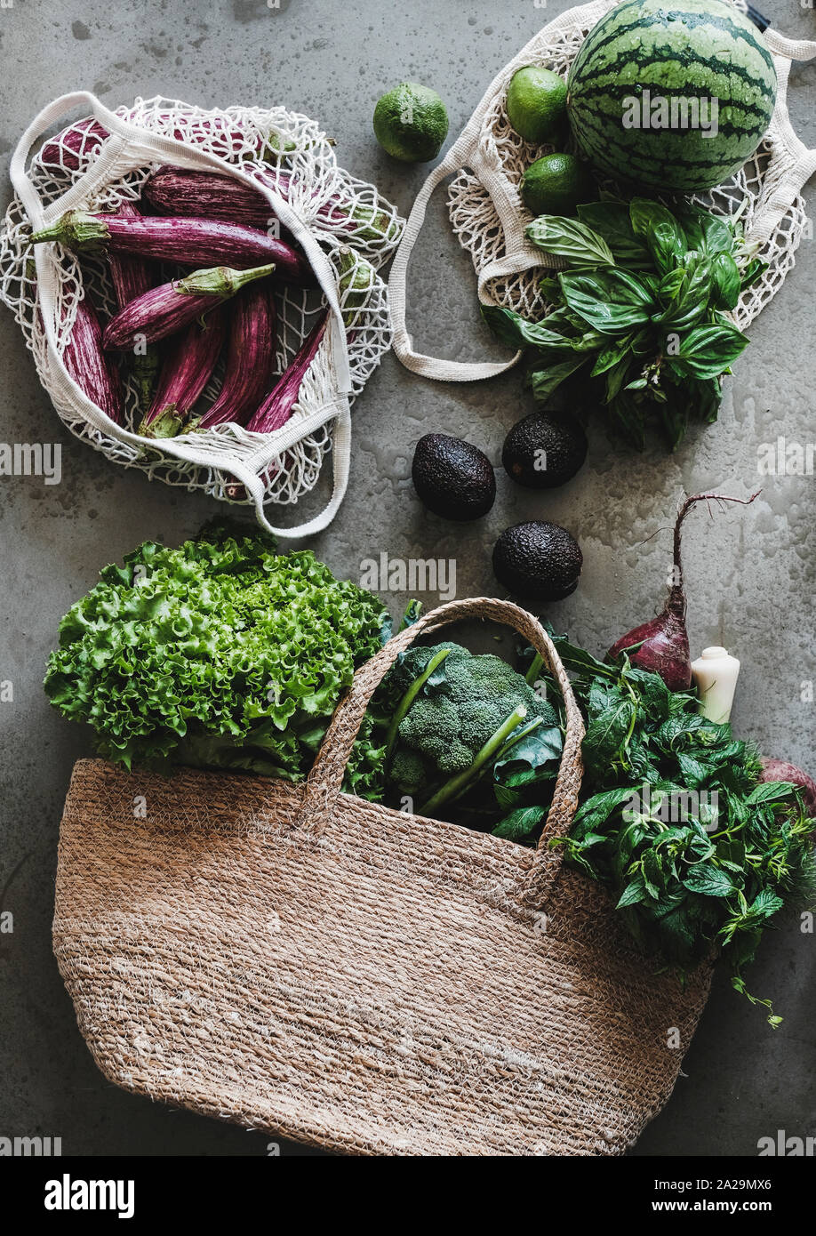 Wicker straw basket made of recycled materials. grocery mesh string eco bag.  sustainable shopping and home. recycled material gifts. eucaliptus leaves  Stock Photo - Alamy